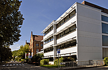 Modernes Schulgebäude, im Hintergrund der neugotische Altbau