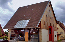 Haus mit großer Glasfront und Solarzellen auf dem Dach