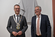 Zwei Personen stehen nebeneinander und lachen. Auf der linken Seite sieht man Oberbürgermeister Stephan Neher. 