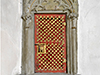 Wandnische mit Türgitter und Steinreliefrahmen