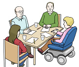 Vier Personen arbeiten an einem Tisch zusammen