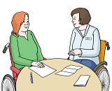 Zwei Menschen mit Behinderung sitzen am Tisch und sprechen